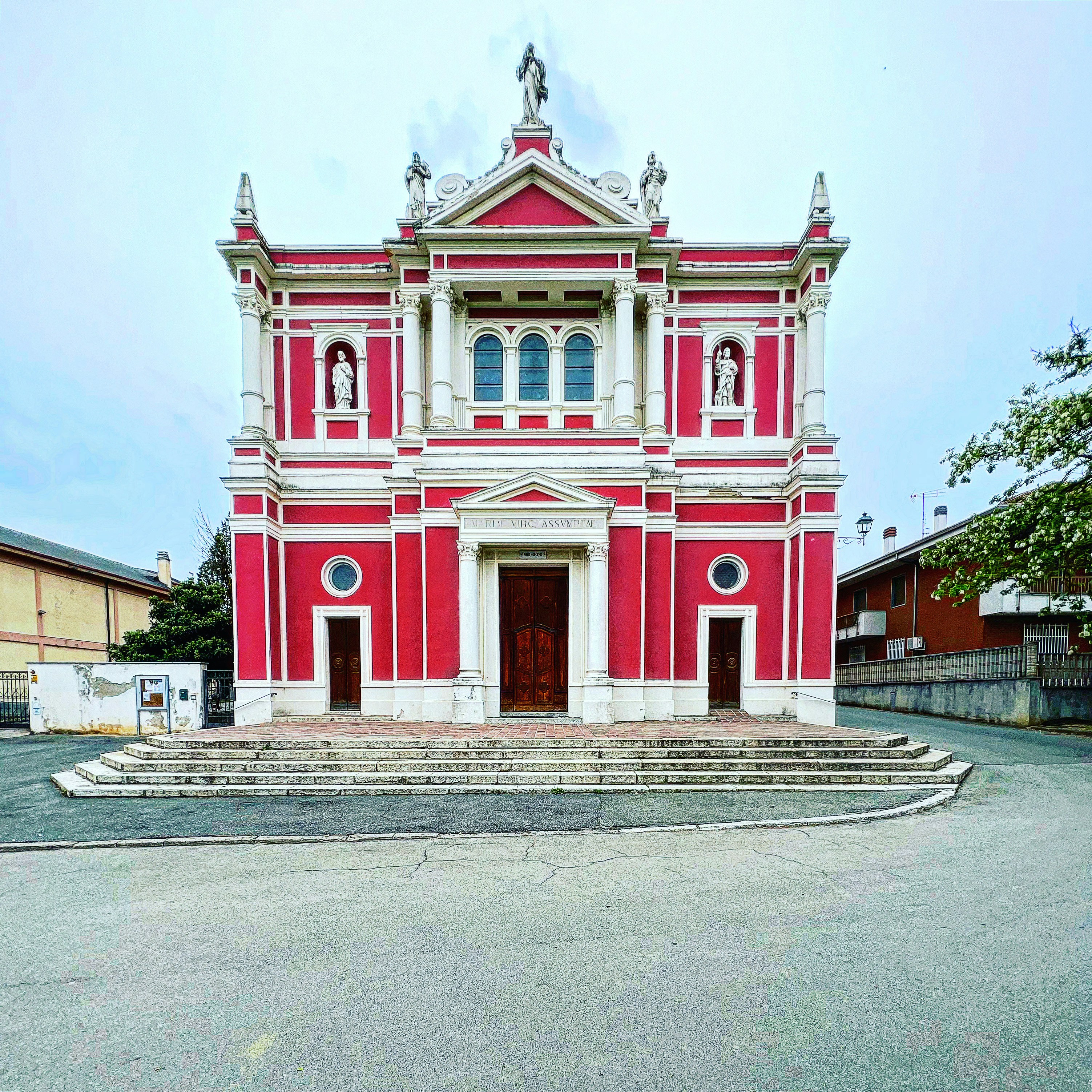 a white building with a red door