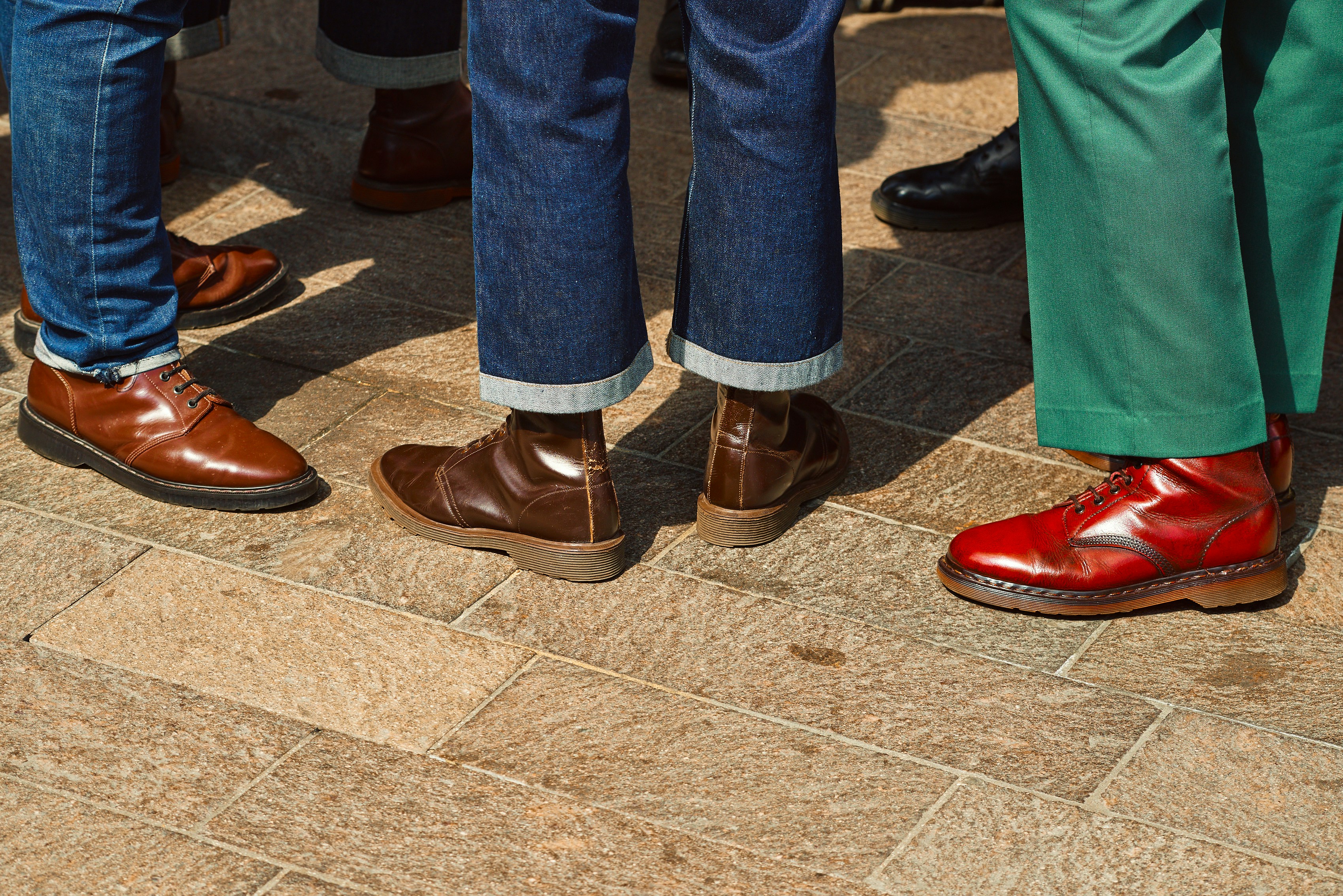 a group of people's legs wearing red shoes