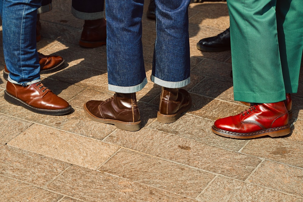a group of people's legs wearing red shoes