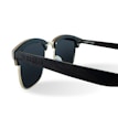 A pair of stylish sunglasses with dark lenses and a wooden frame. The arms have a slightly curved design and the frame includes metallic accents. The sunglasses display intricate detailing on the side, giving a modern and chic appearance.