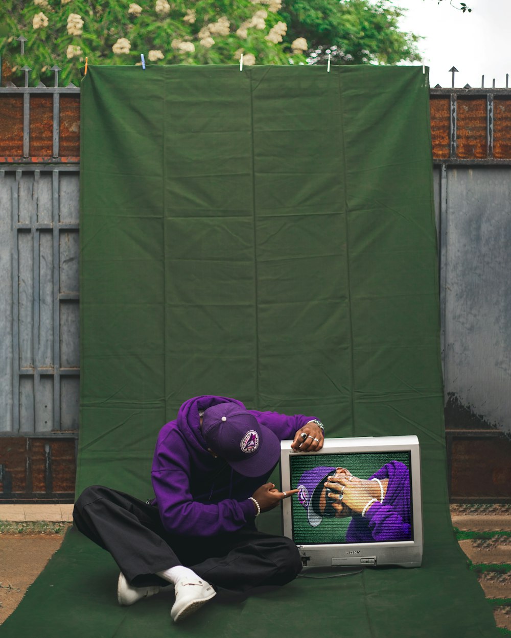 a person lying on the ground with a laptop in front of him