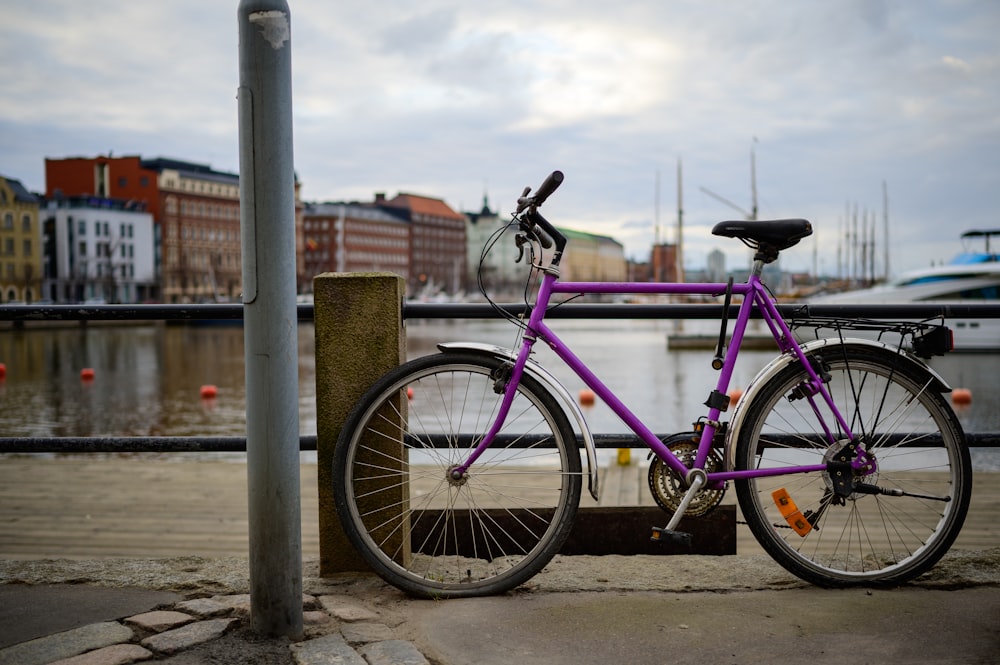 a purple bicycle parked on a dock