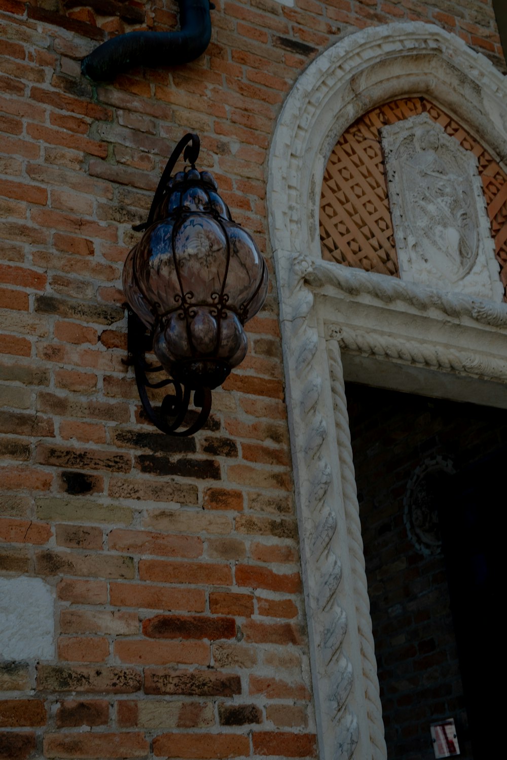 a statue on a brick wall