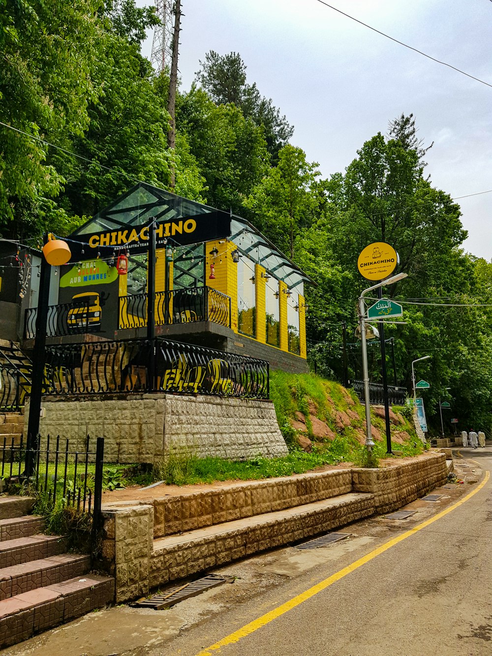 a yellow trolley car on a road