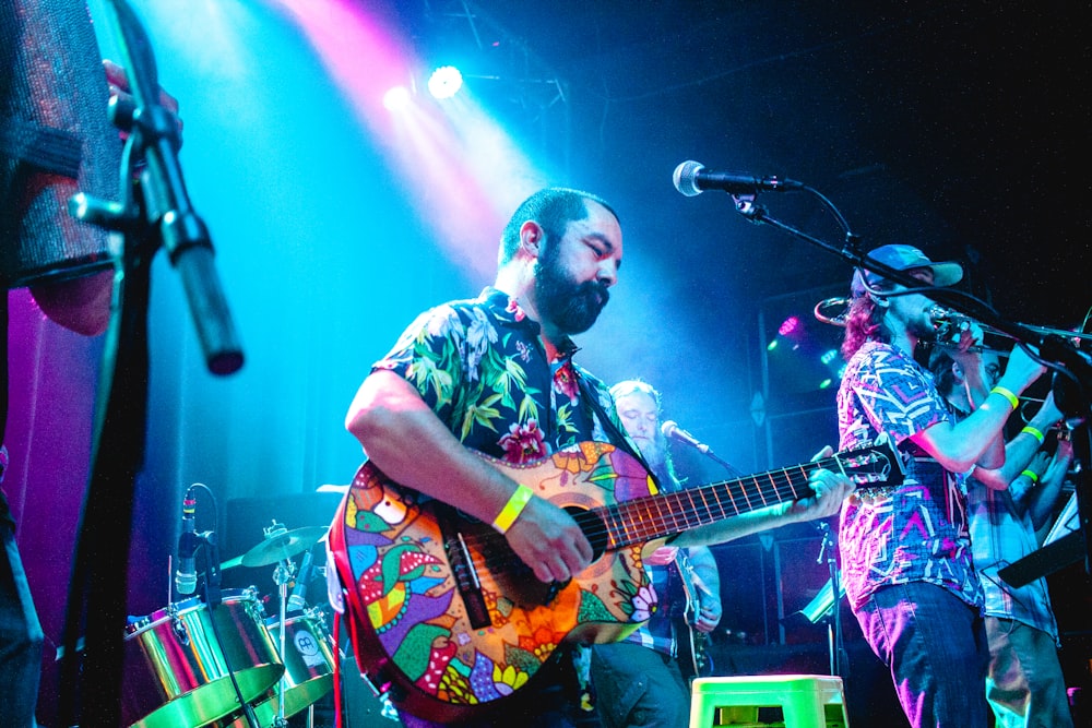 a person playing a guitar on a stage