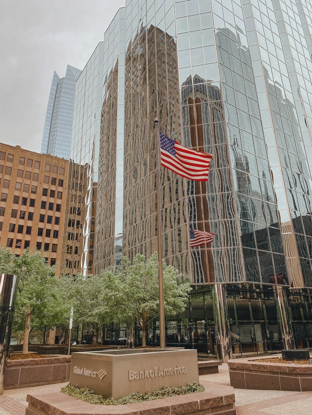 a flagpole with a flag in front of a building