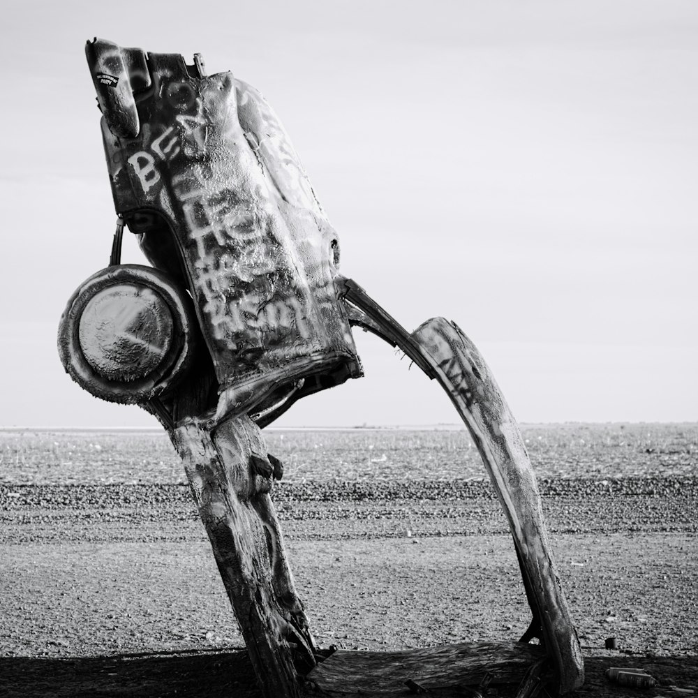 a metal sculpture on a wooden post