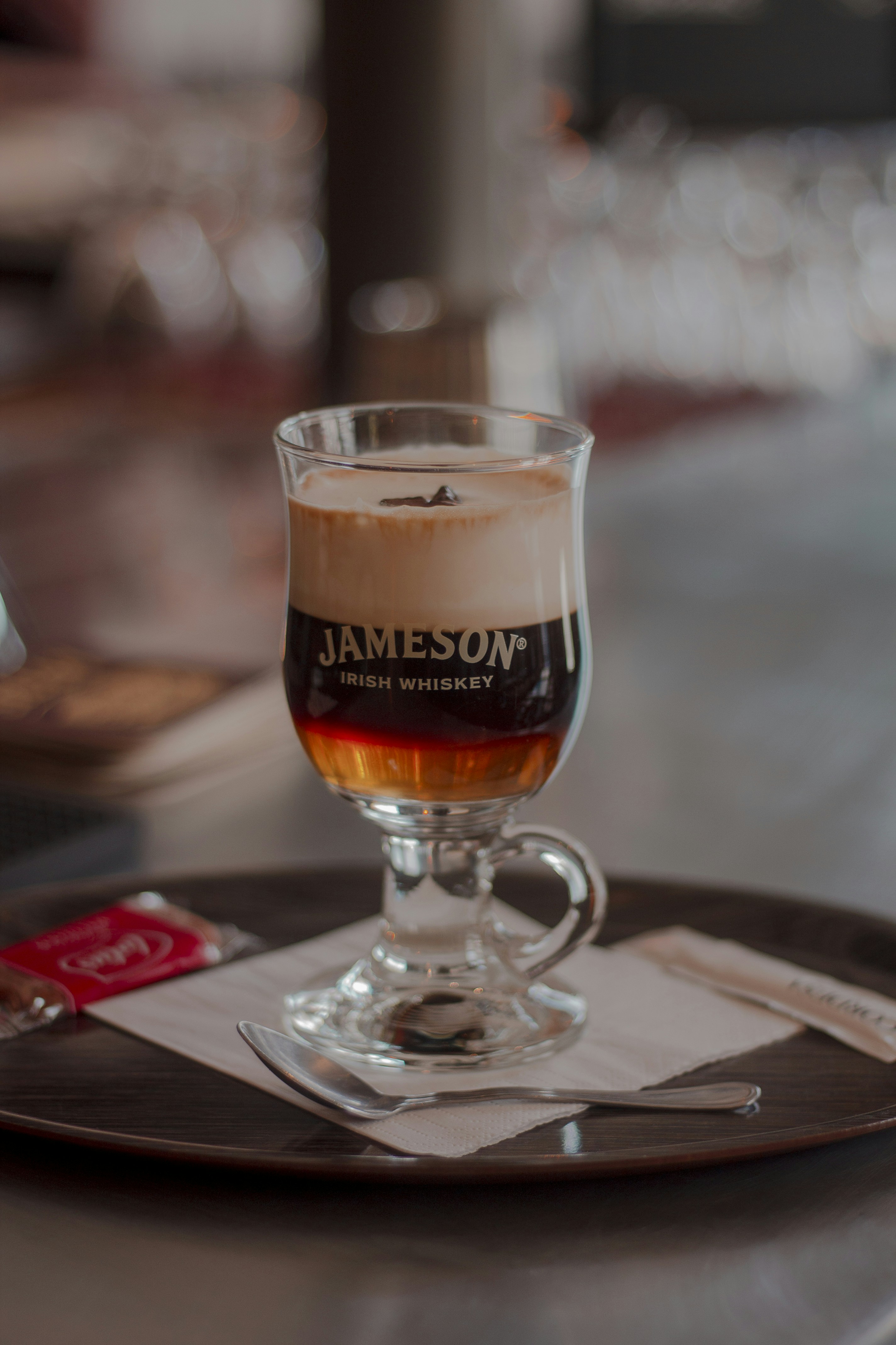 a glass of beer on a coaster