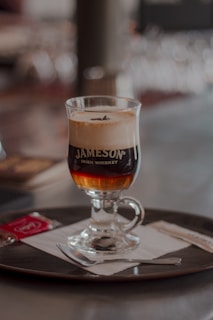 a glass of beer on a coaster