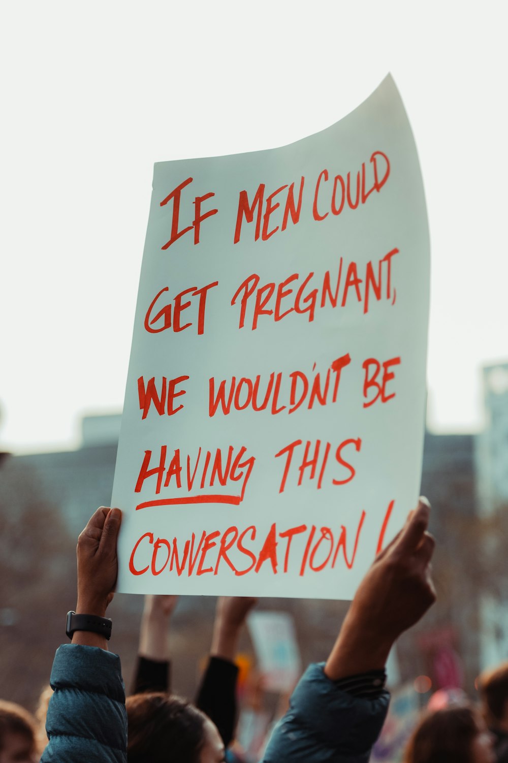 a group of people holding up a sign