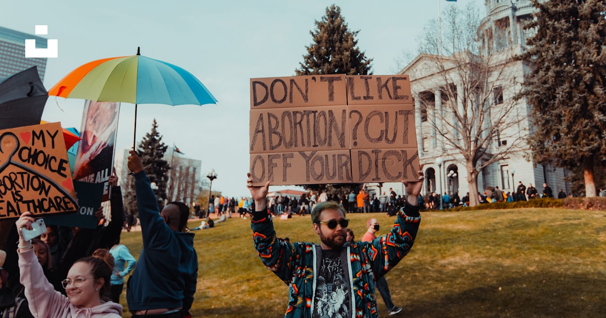 A group of people holding signs and a sign photo – Free Denver Image on ...
