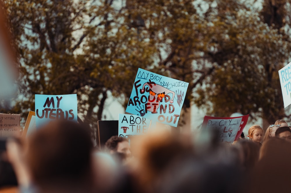 a group of people holding signs