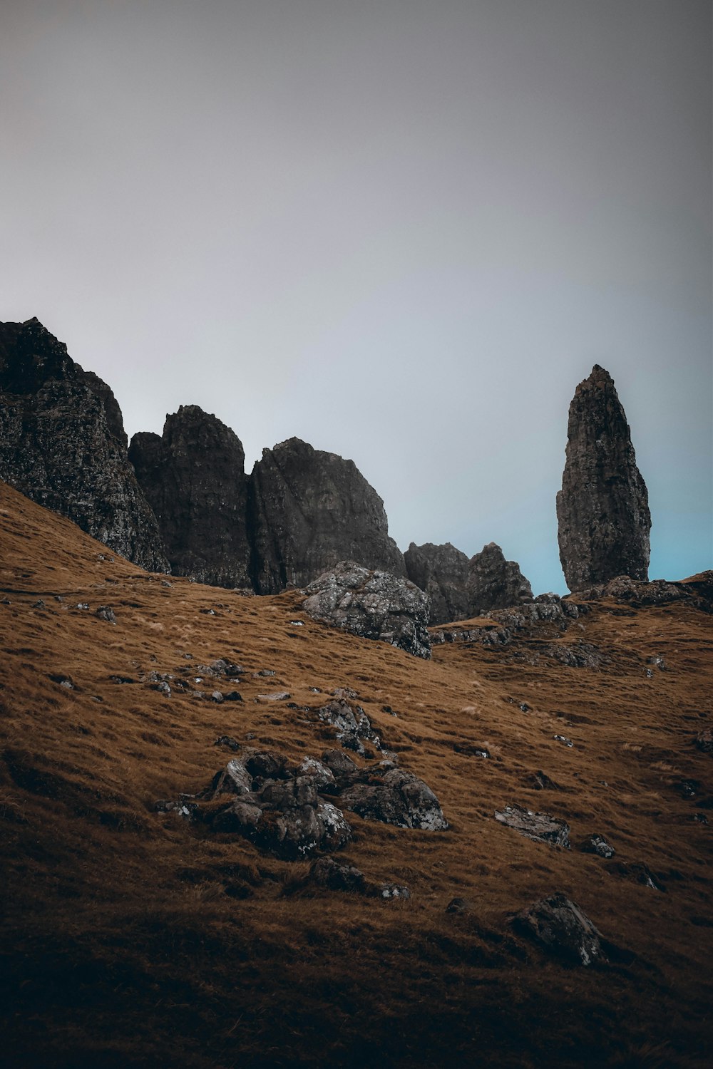 a rocky mountain with a few tall rocks on it