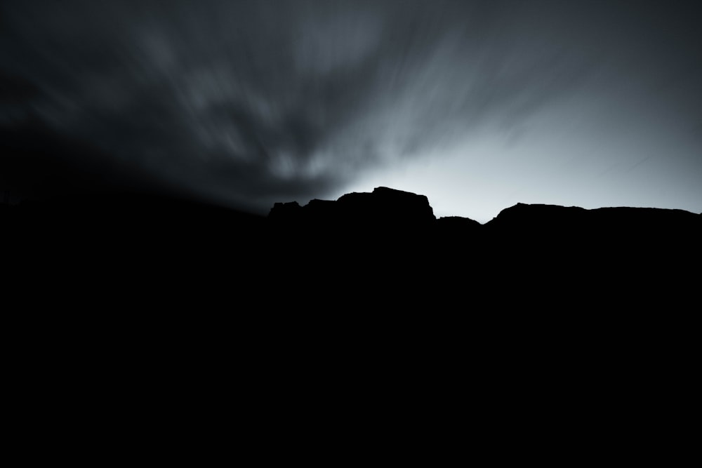 a dark landscape with a dark sky