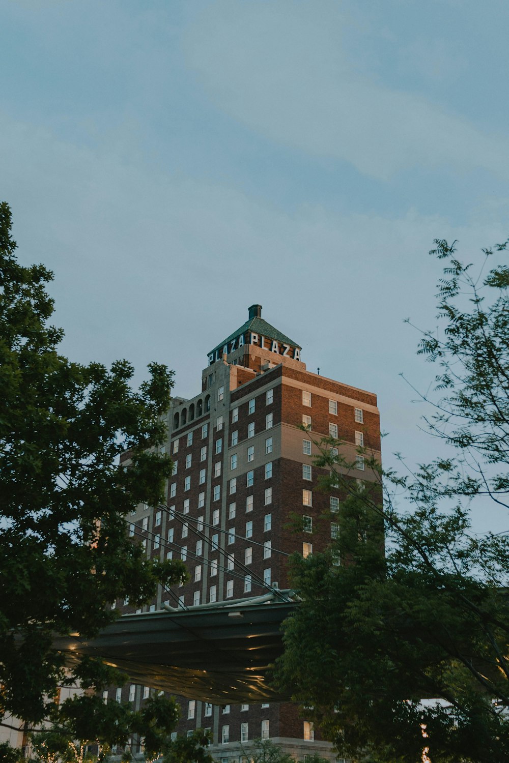 a tall building with trees in front of it