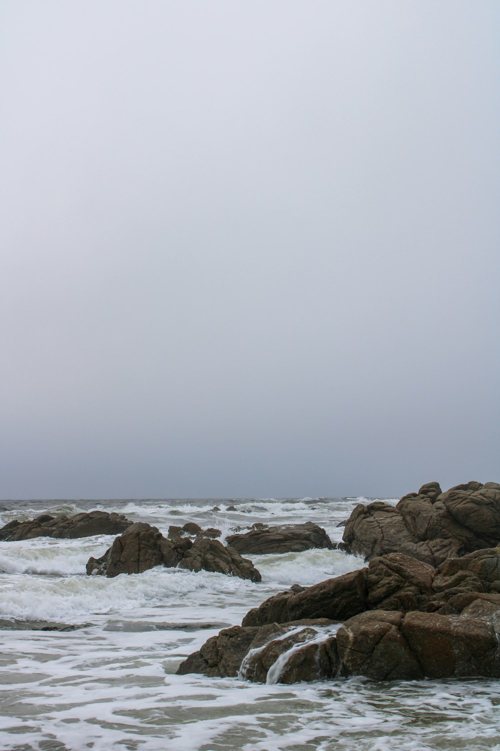 a rocky beach with waves crashing