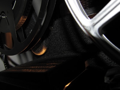 Close-up of a vintage Super 8 film reel being carefully handled.