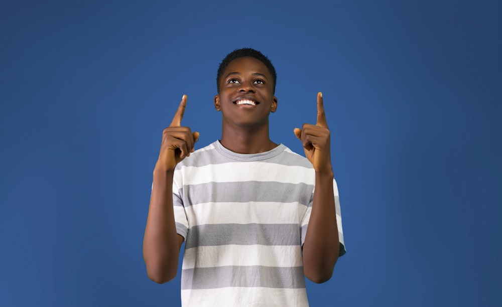 a boy holding up his hands