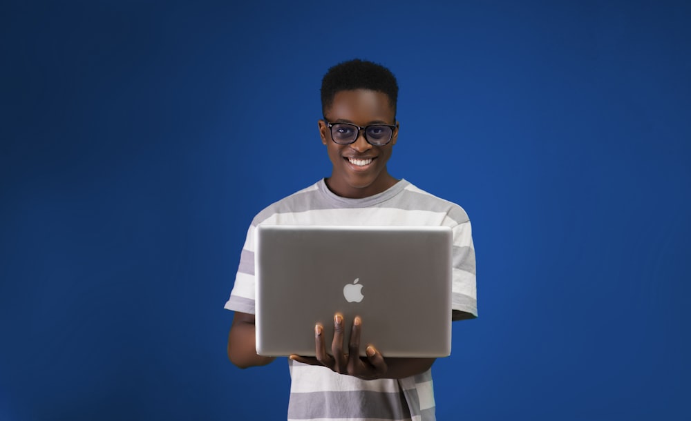 a man holding a laptop