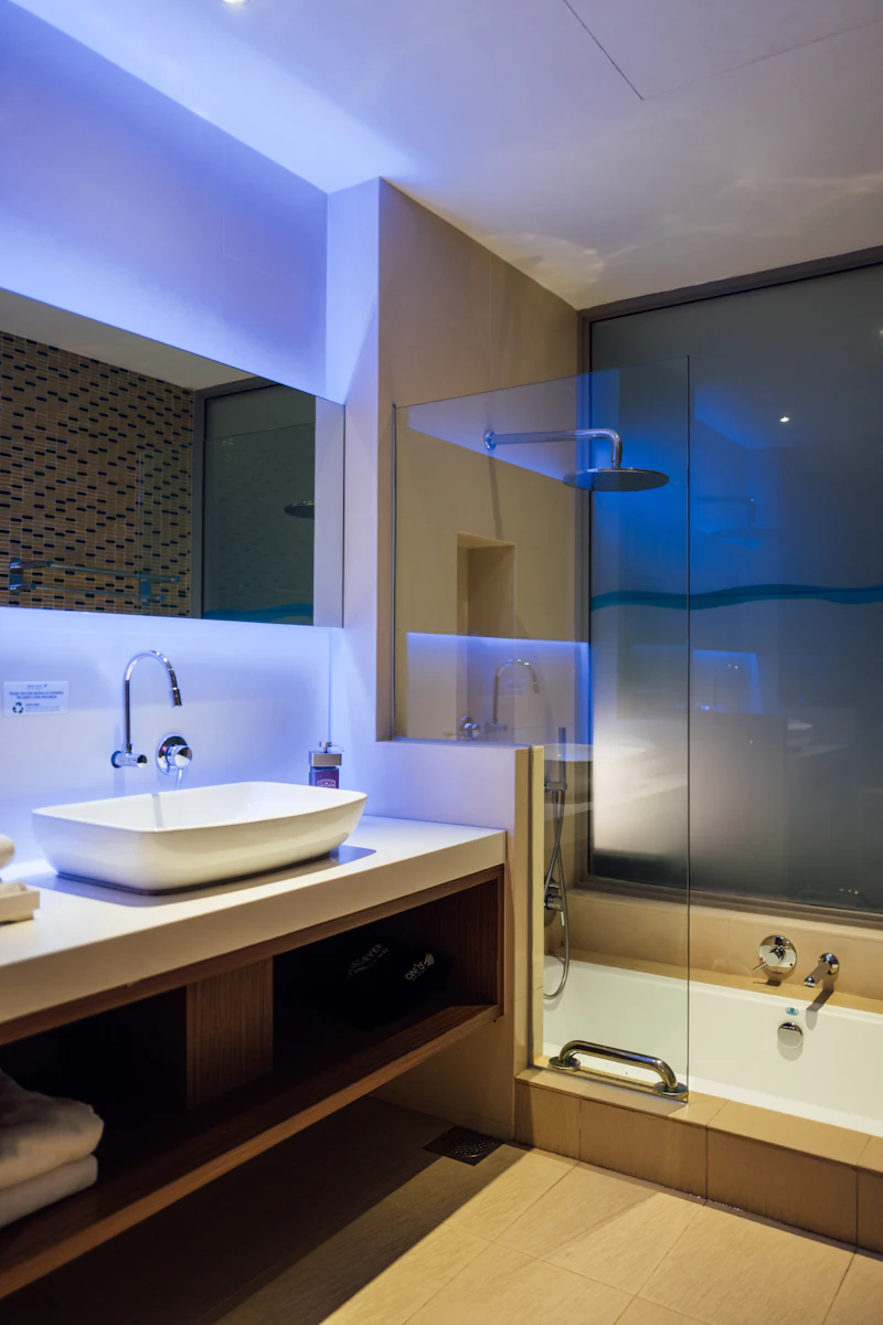 Frameless glass shower door in a tiled bathroom