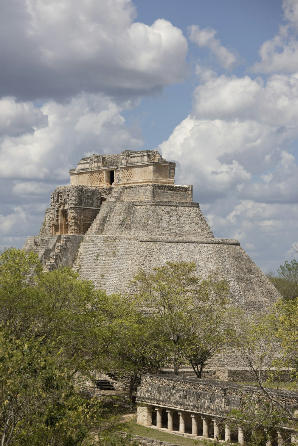 a stone castle with trees in front of it