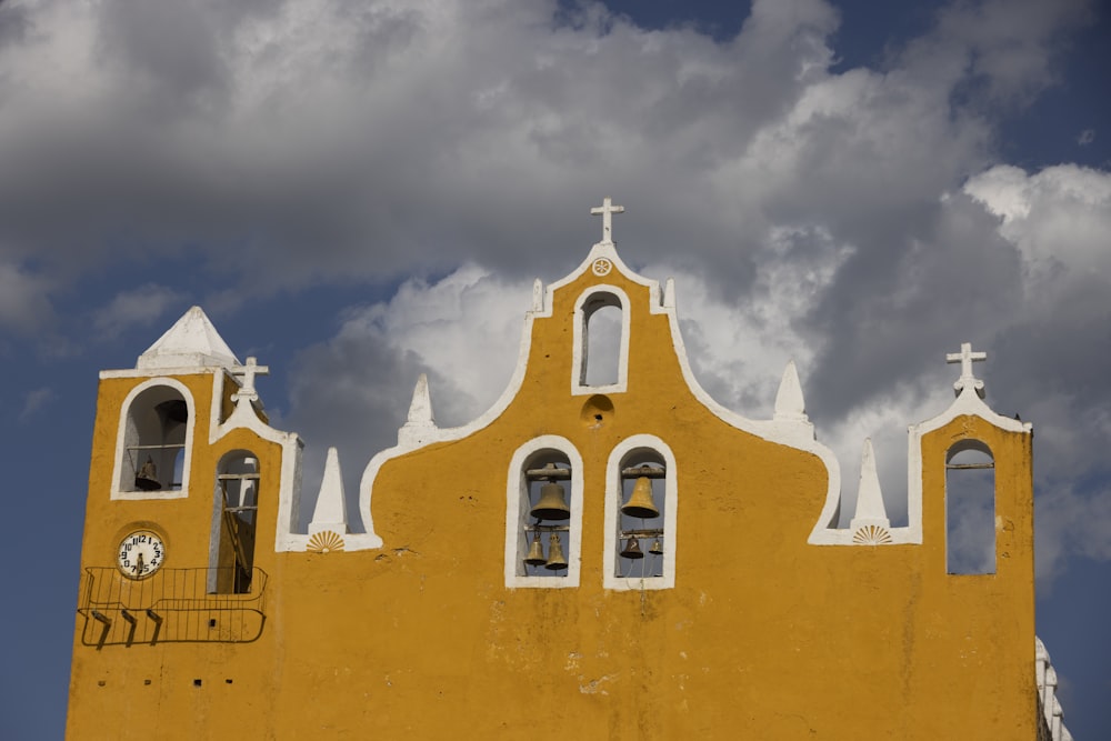 a yellow building with a clock on it