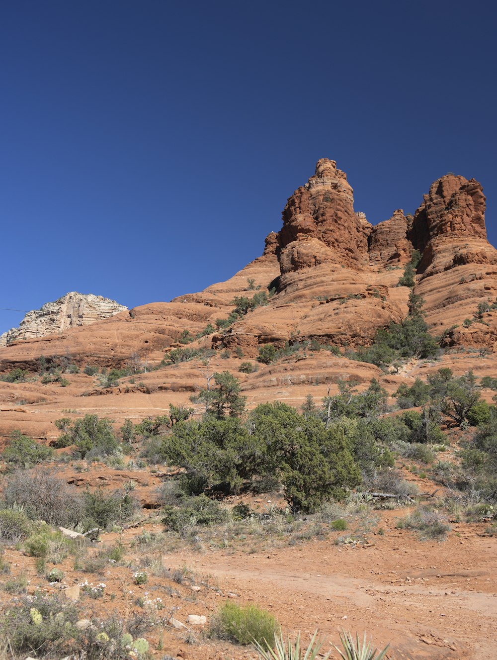 a desert landscape with a few tall rocky mountains