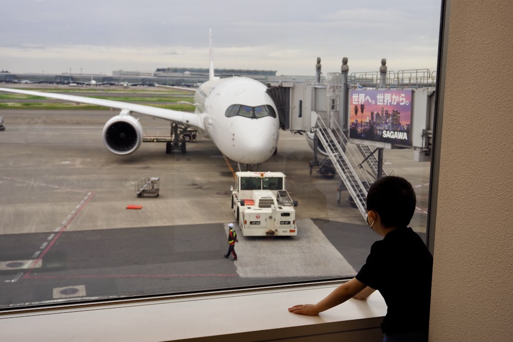 a person standing next to an airplane