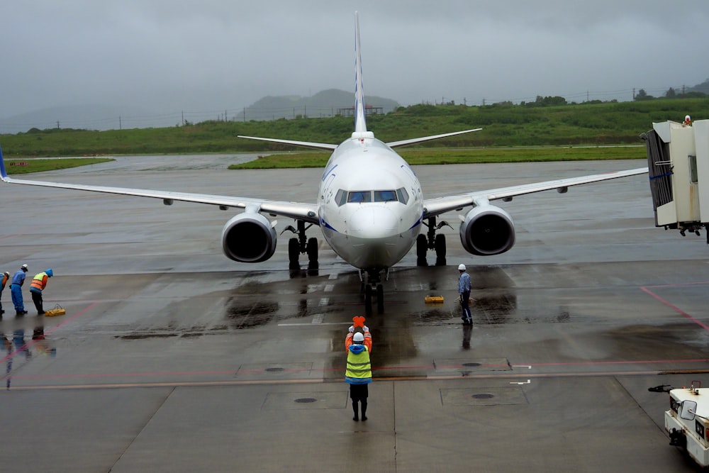 a group of people stand near an airplane