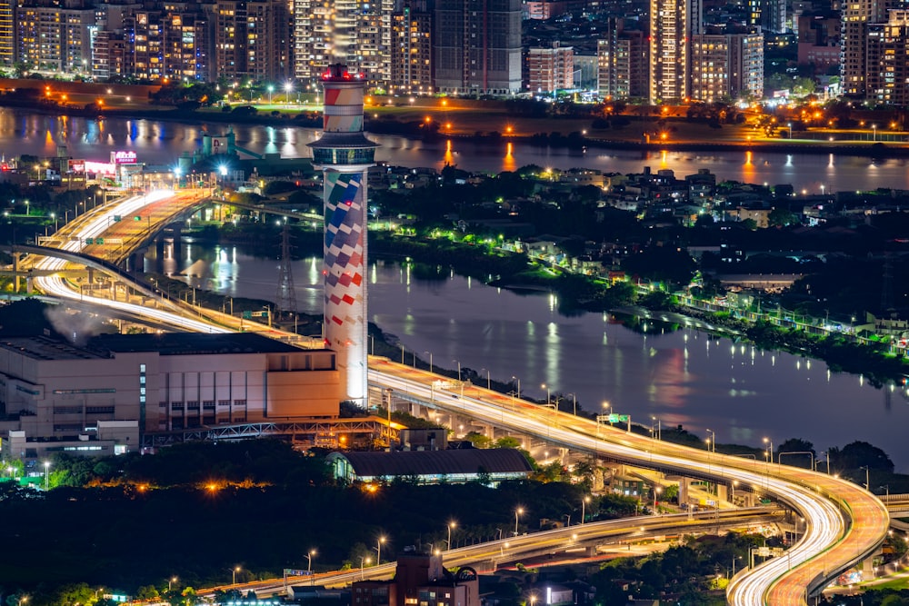 a city with a bridge and a river with a tower