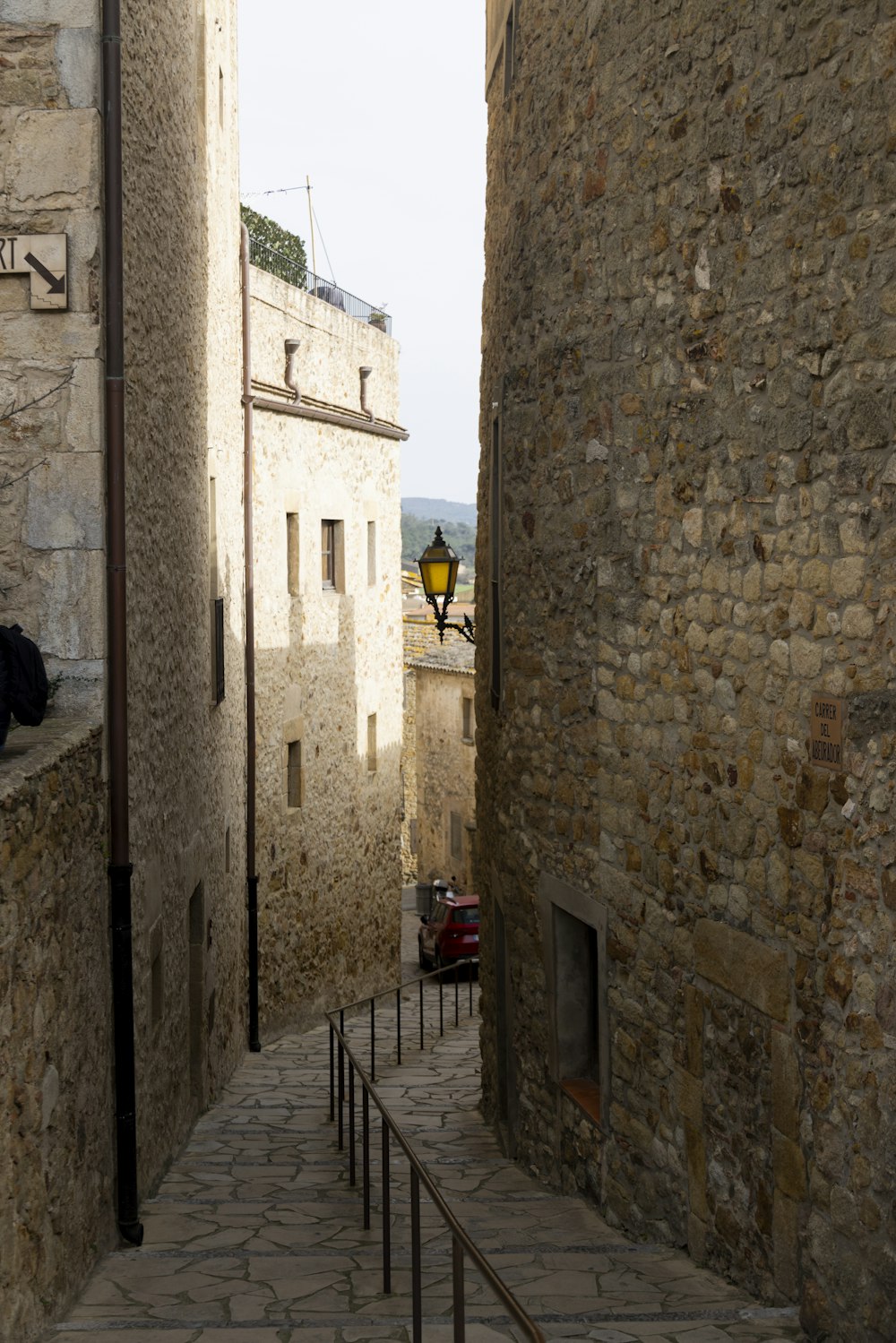 a narrow street between stone buildings