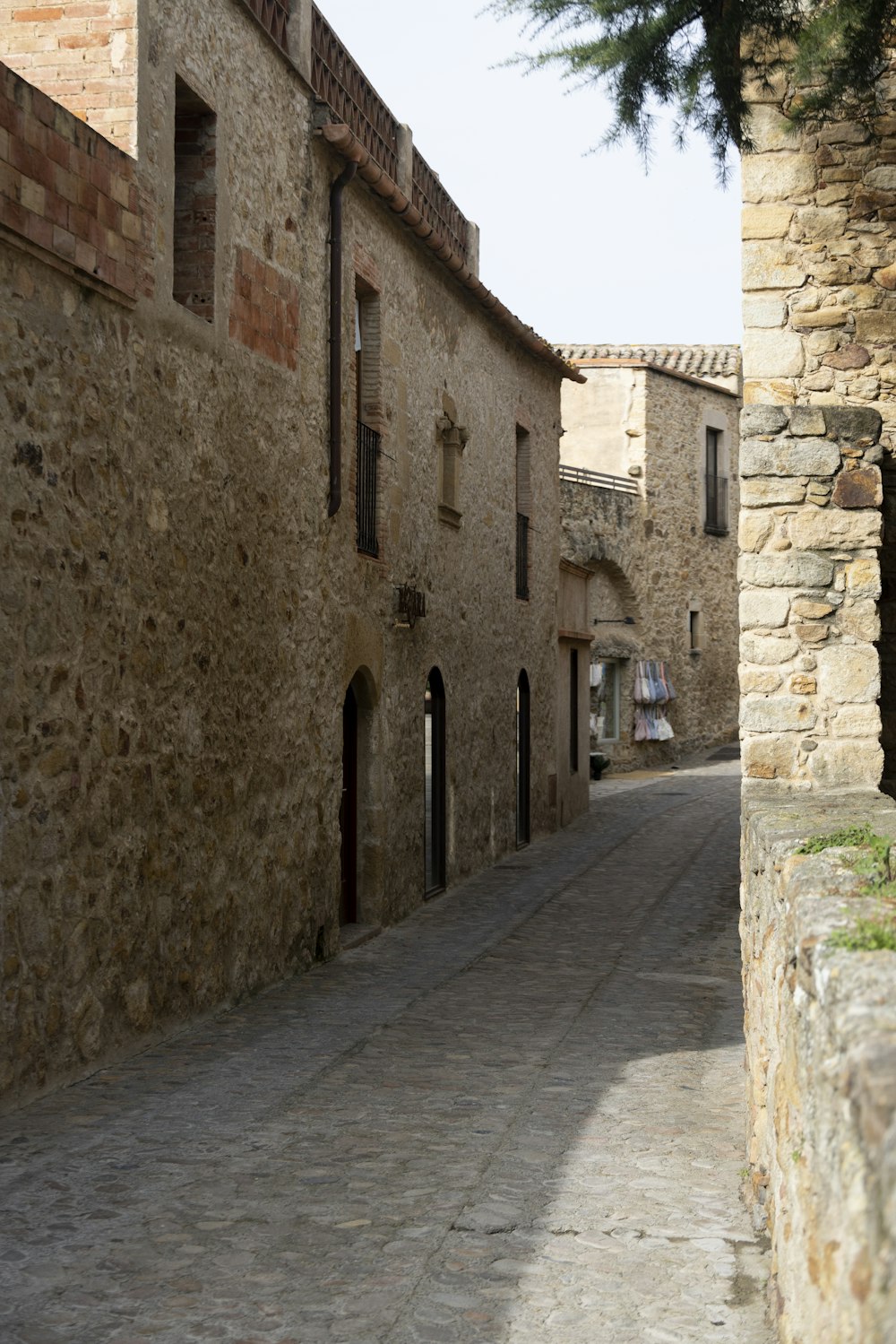 a stone street between two stone buildings