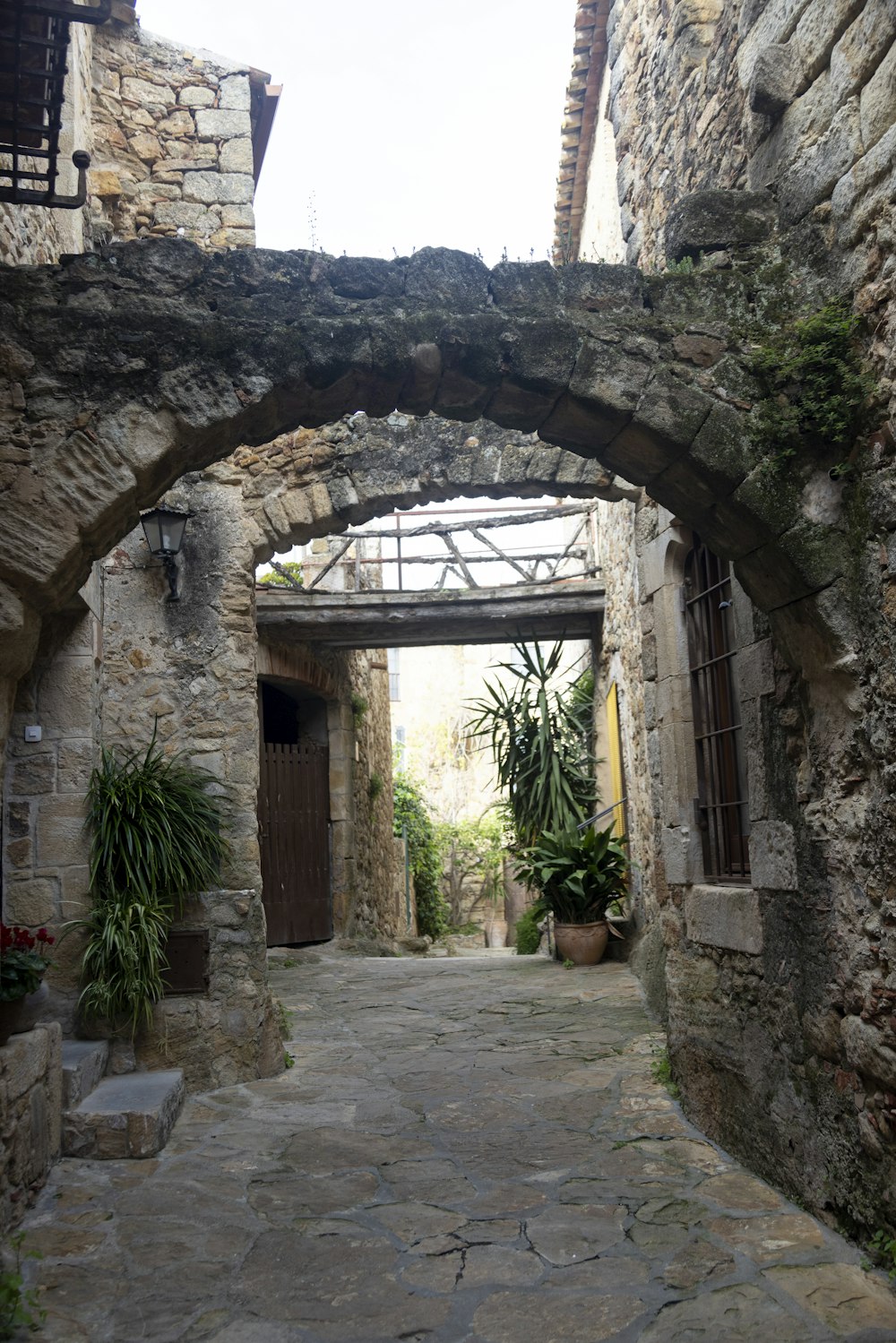 a stone walkway between stone buildings