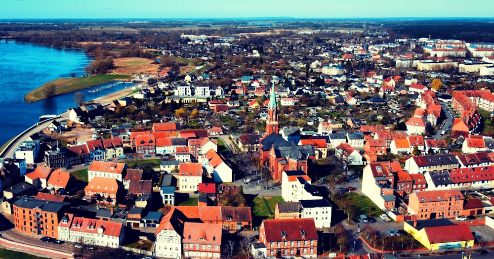 a city with red roofs by the water