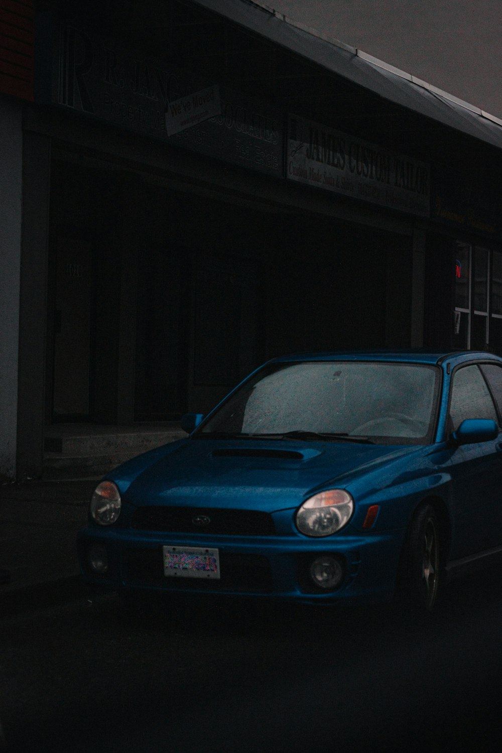 a blue car parked in a garage