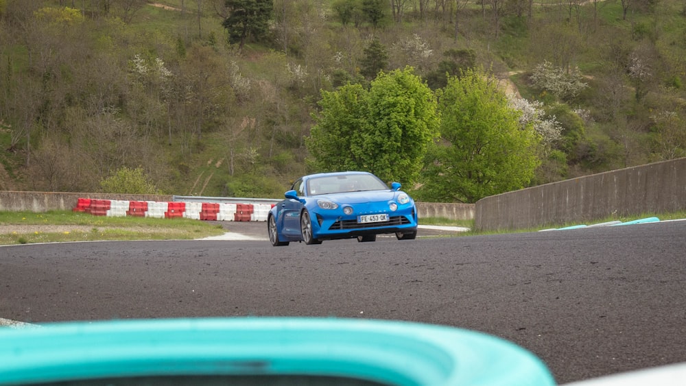 a blue car on a road