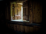 Interior view of a wooden frame house with natural light.