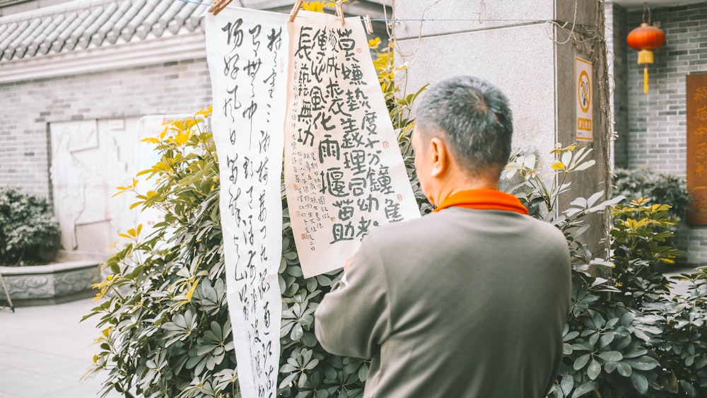 a man looking at a sign