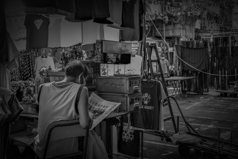 a person reading a newspaper in a shop