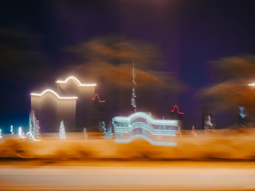 a large building with a tower and a fountain in front of it