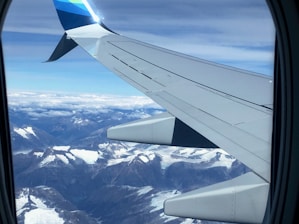 A scenic view from an airplane window flying over the Andes mountains heading to Peru.