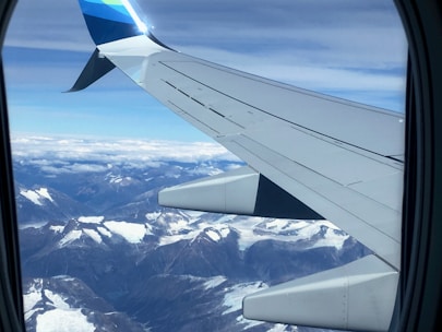 A scenic view from an airplane window flying over the Andes mountains heading to Peru.