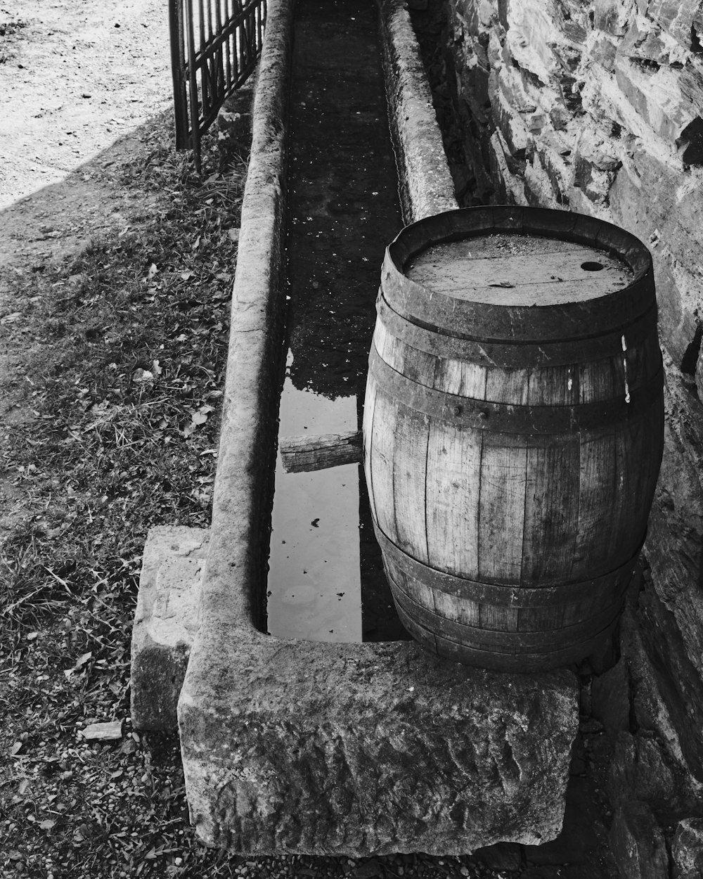 a barrel on a stone wall