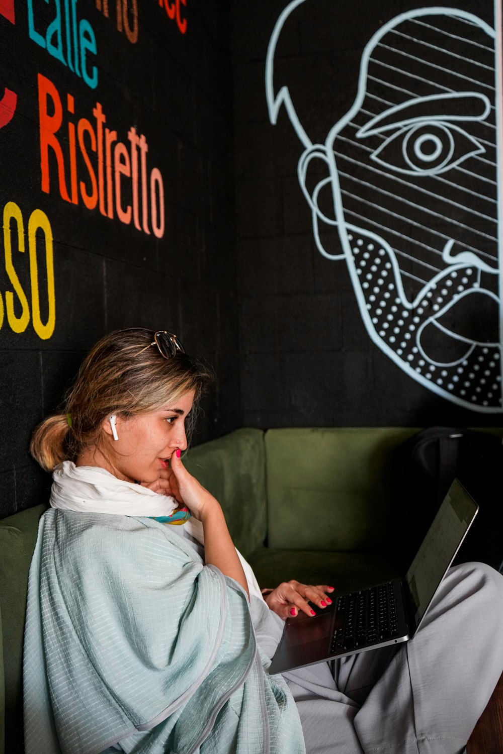 a person sitting on a bench with a laptop