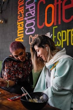 Friendly advisor speaking with a Spanish-speaking couple at a kitchen table