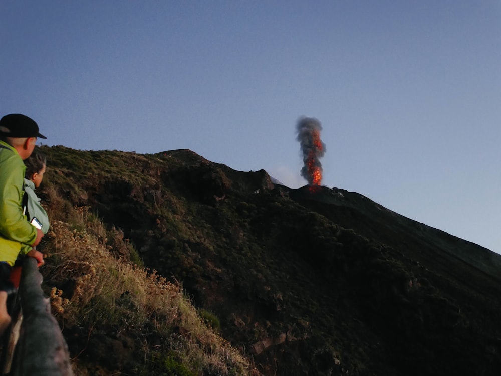 a man looking at a volcano