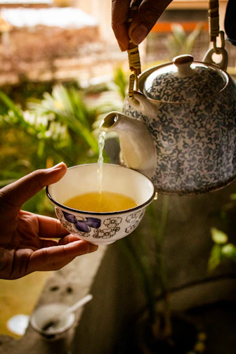 a hand holding a tea cup