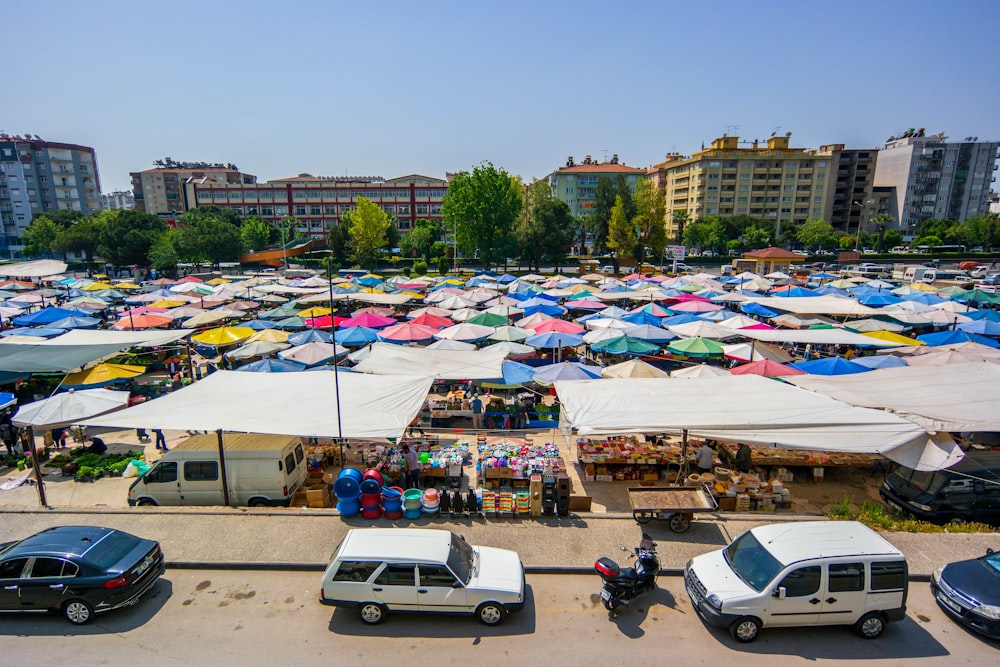 a large group of tents are set up in a parking lot