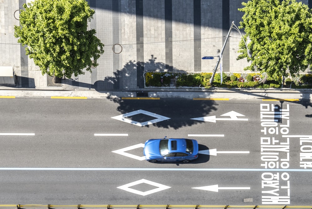 a blue car on a road