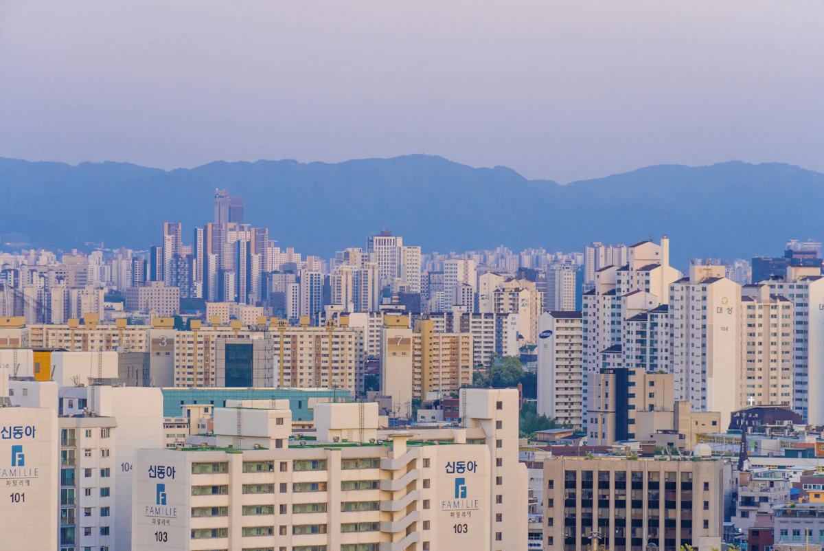 Apartment blocks across Seoul with mountains behind